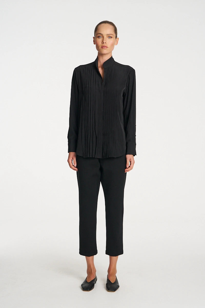 Woman wearing Mela Purdie Balcony Blouse F67 8970 in Black, front view showing the pleated panels
