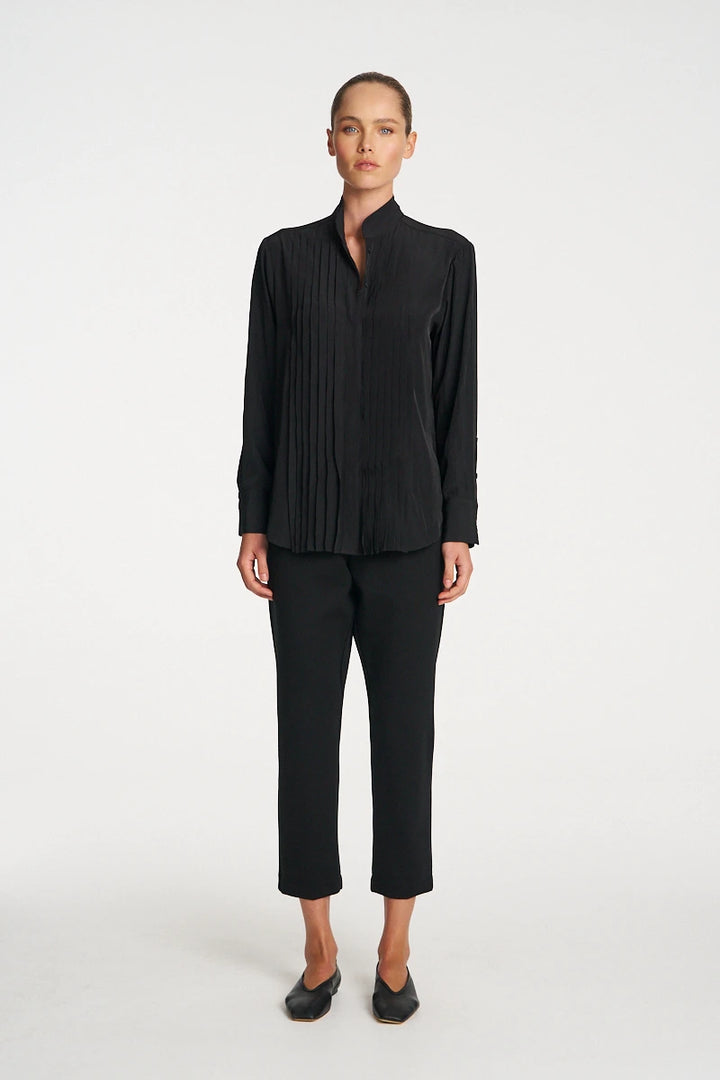 Woman wearing Mela Purdie Balcony Blouse F67 8970 in Black, front view showing the pleated panels