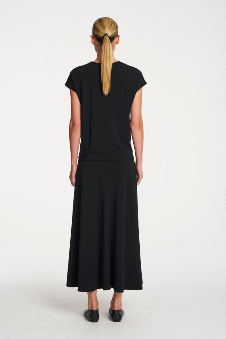 Woman wearing Mid Skirt in Black by Mela Purdie back