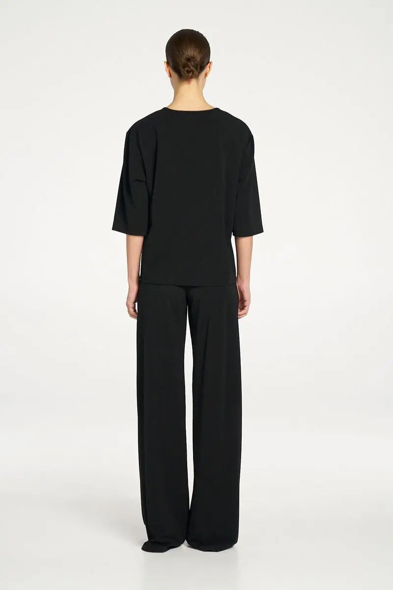Woman wearing Plaza Crew Top in Black by Mela Purdie back