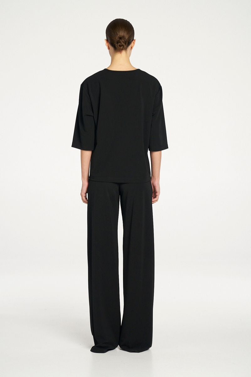 Woman wearing Plaza Crew Top in Black by Mela Purdie back