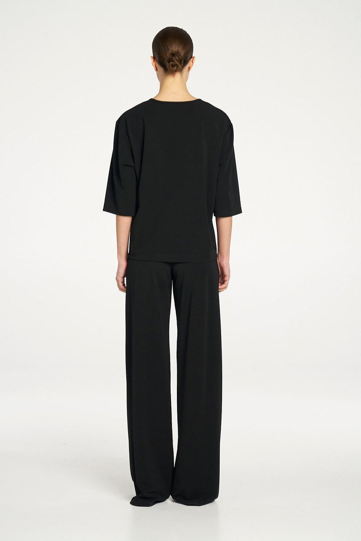 Woman wearing Plaza Crew Top in Black by Mela Purdie back