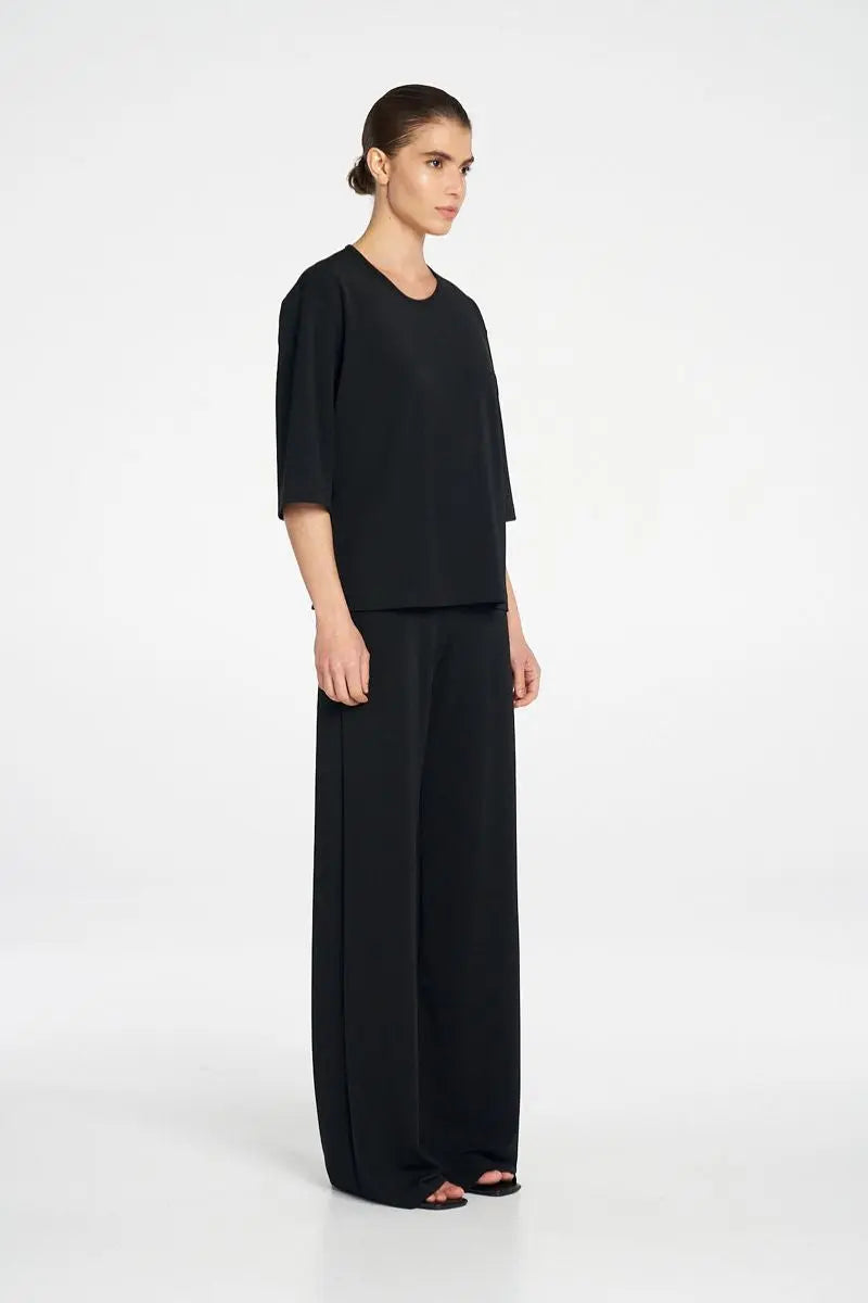Woman wearing Plaza Crew Top in Black by Mela Purdie side