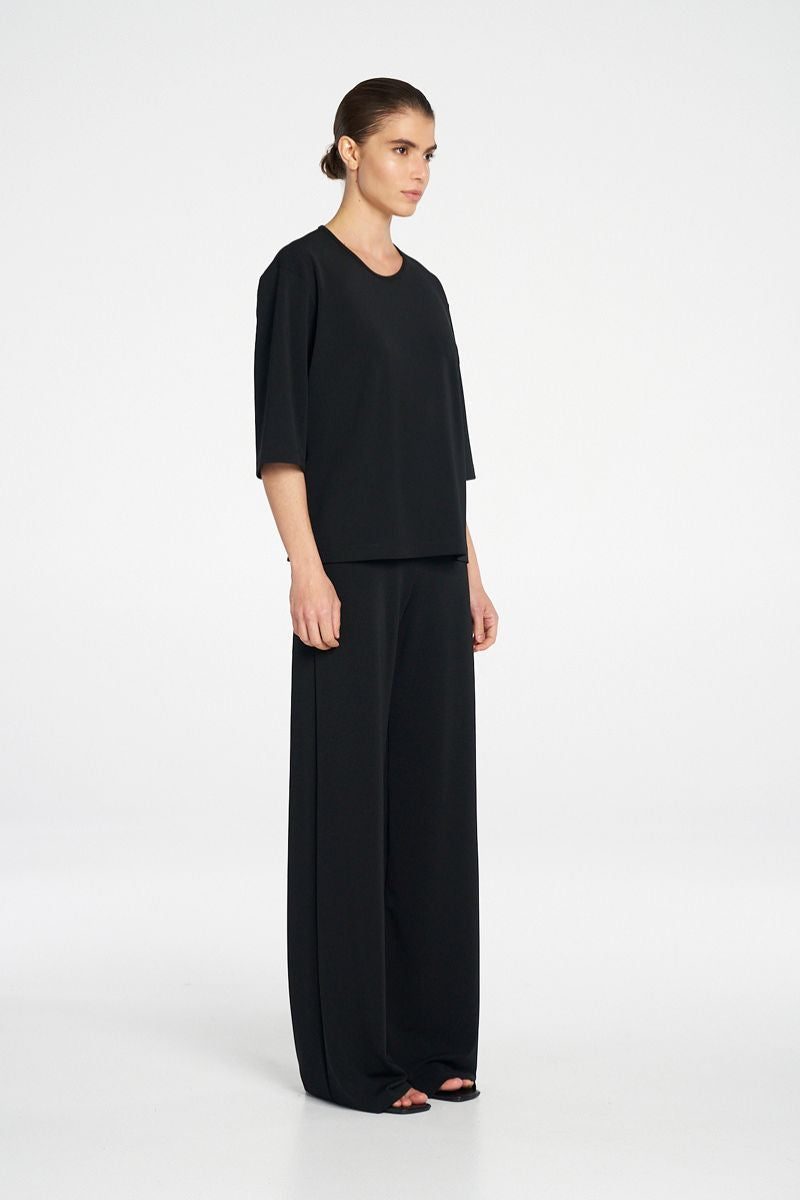 Woman wearing Plaza Crew Top in Black by Mela Purdie side