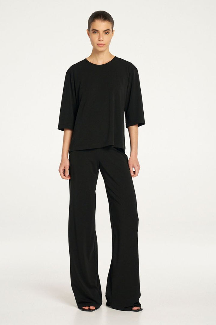 Woman wearing Plaza Crew Top in Black by Mela Purdie styled