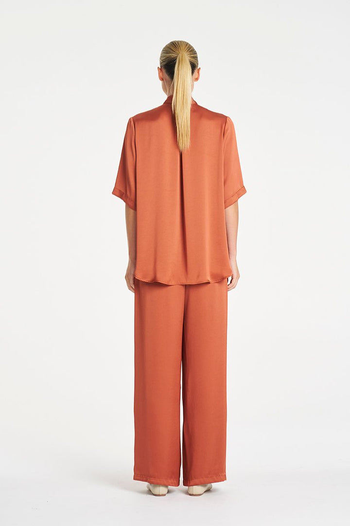 Woman wearing Swish Tux Plaza in Copper Mirror Satin by Mela Purdie back