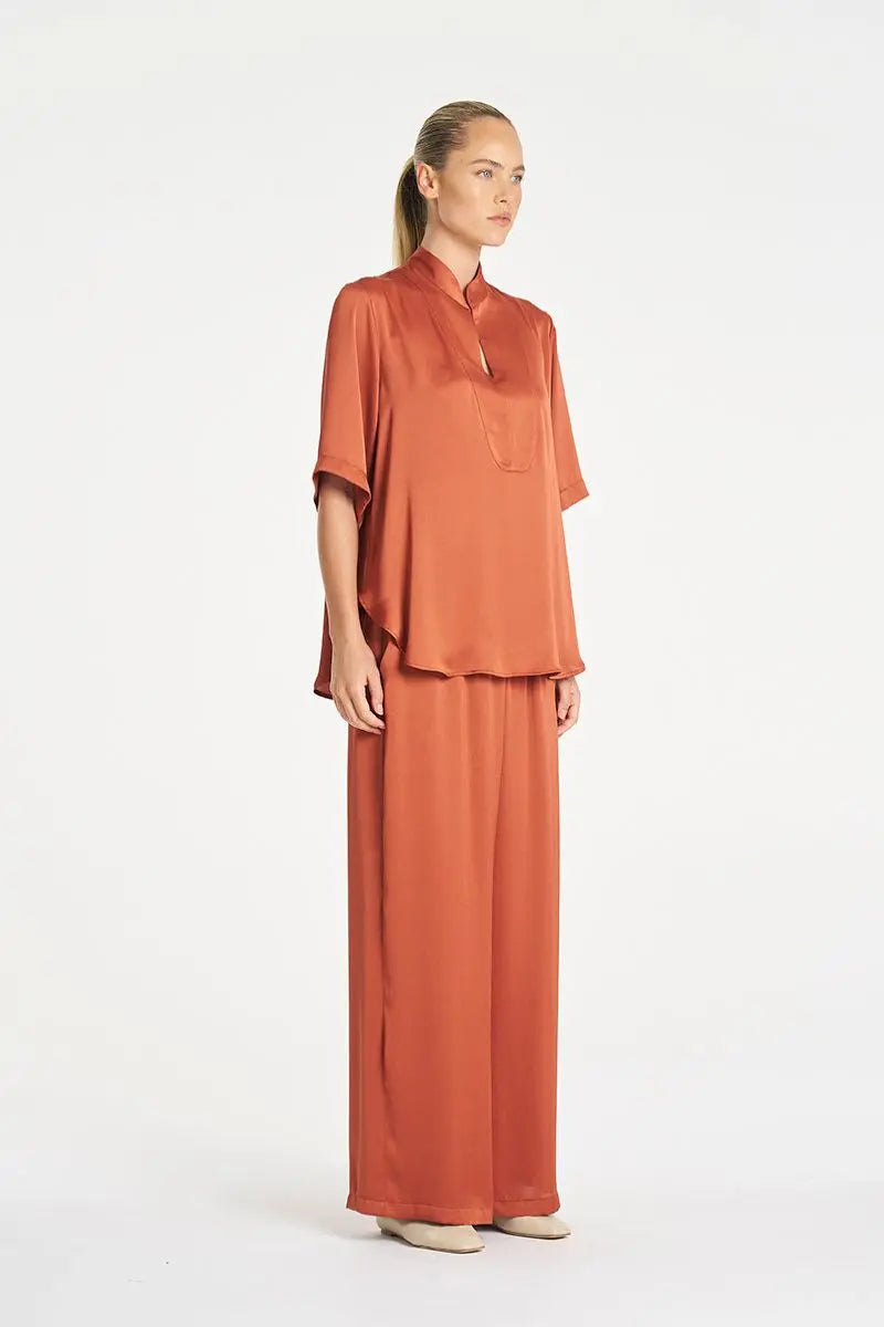 Woman wearing Swish Tux Plaza in Copper Mirror Satin by Mela Purdie side
