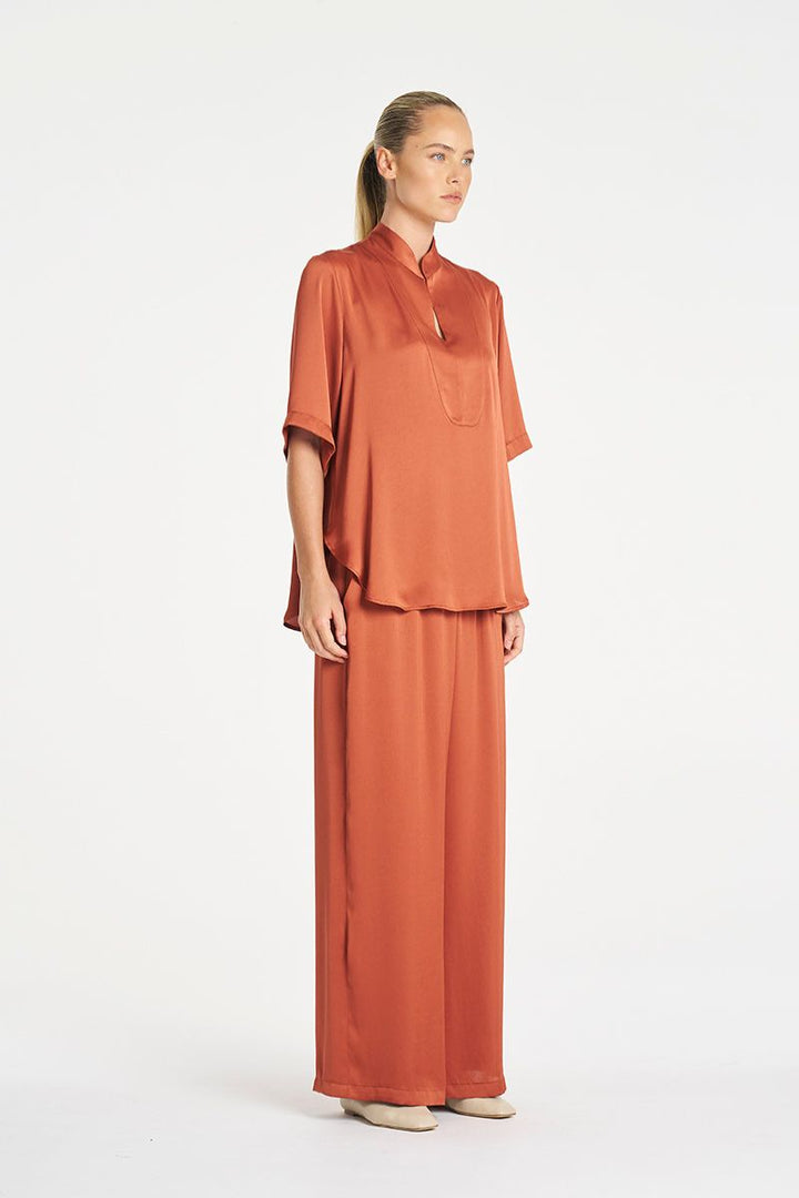 Woman wearing Swish Tux Plaza in Copper Mirror Satin by Mela Purdie side