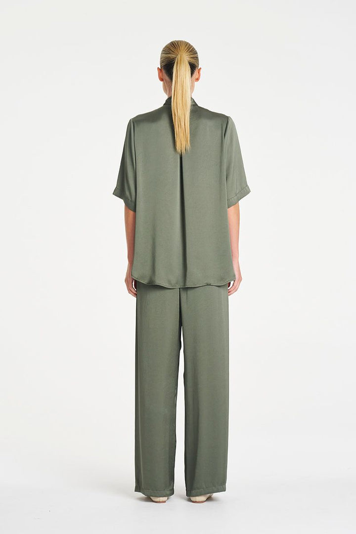 Woman wearing Swish Tux Plaza in Sage Mirror Satin by Mela Purdie back