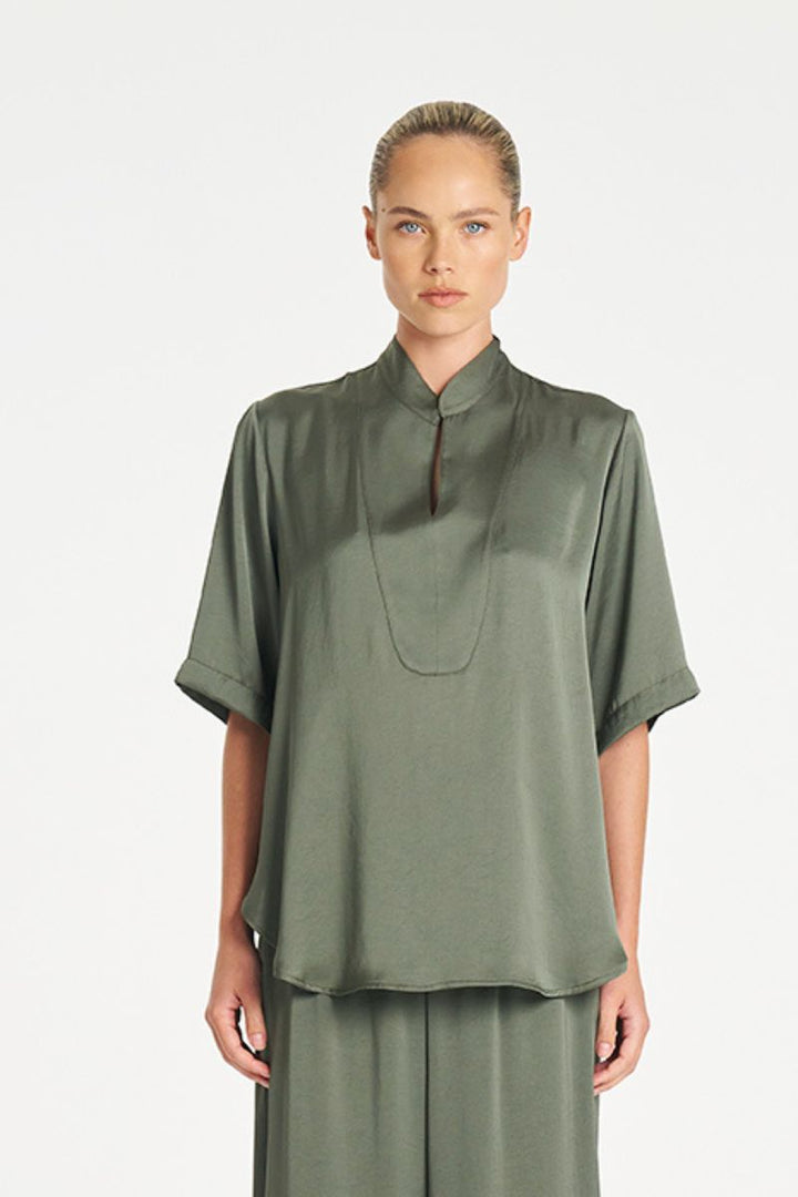 Woman wearing Swish Tux Plaza in Sage Mirror Satin by Mela Purdie front