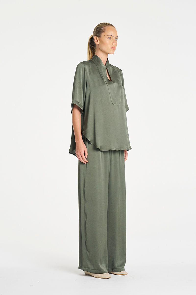 Woman wearing Swish Tux Plaza in Sage Mirror Satin by Mela Purdie side