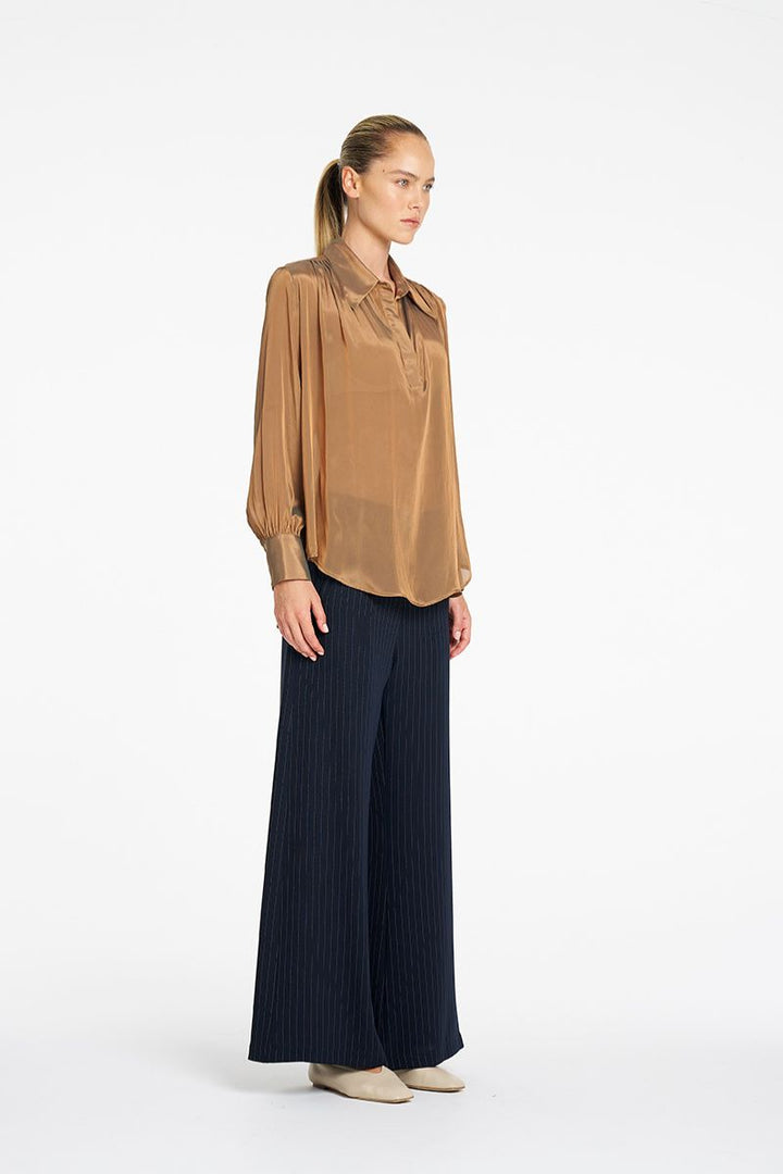 Mela Purdie Atrium Blouse in Syrup side view showing curved hem and sleeve detail