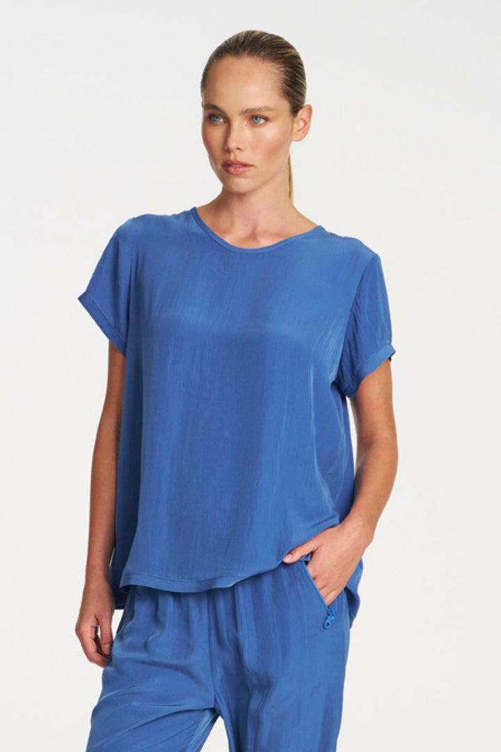 Woman wearing Travel T in Parisian by Mela Purdie front