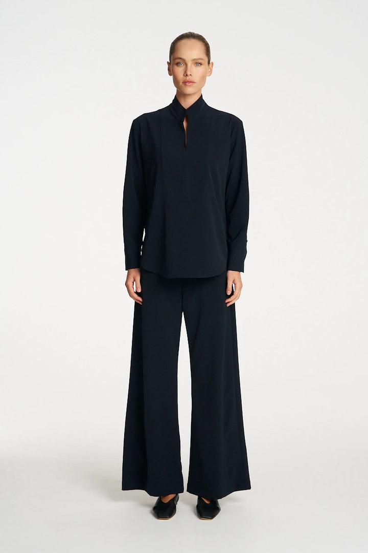Woman wearing Mela Purdie Formal Shirt F618 8956 in Black, front view showing the neckline and cuffs