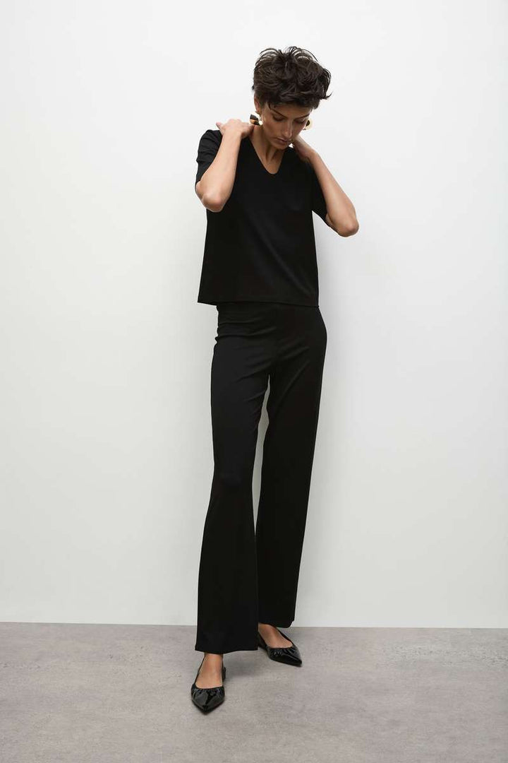 Woman wearing Long Pant in Black by Mela Purdie F01 100, standing outfit view.