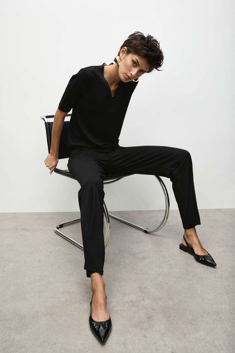 Woman wearing Long Pant in Black by Mela Purdie F01 100, seated outfit view.