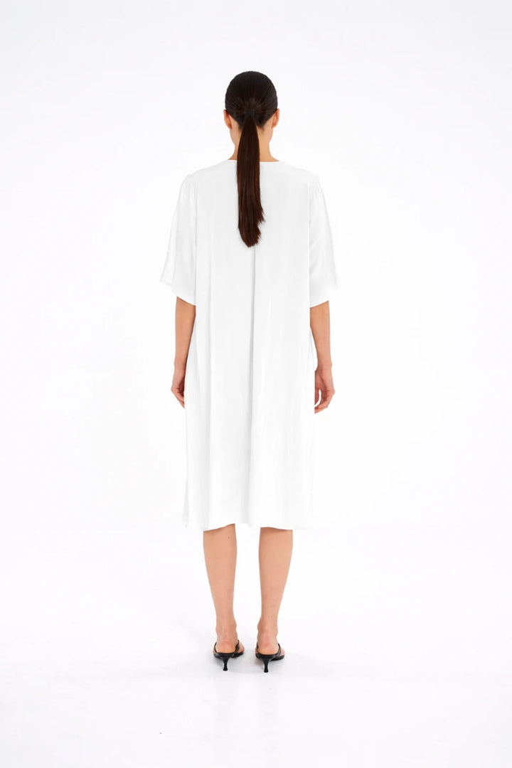 Woman wearing Mela Purdie Plaza Dress F67 3004 in White, back view