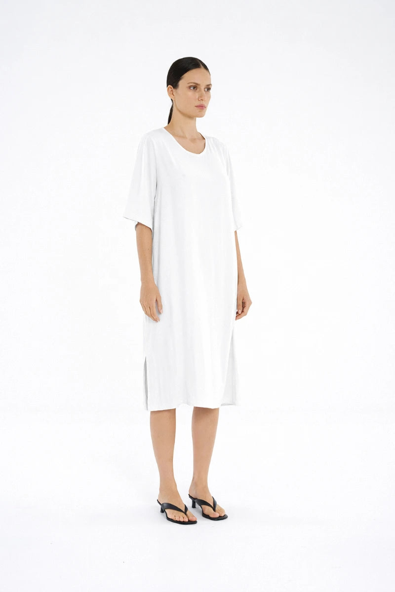 Woman wearing Mela Purdie Plaza Dress F67 3004 in White, side view