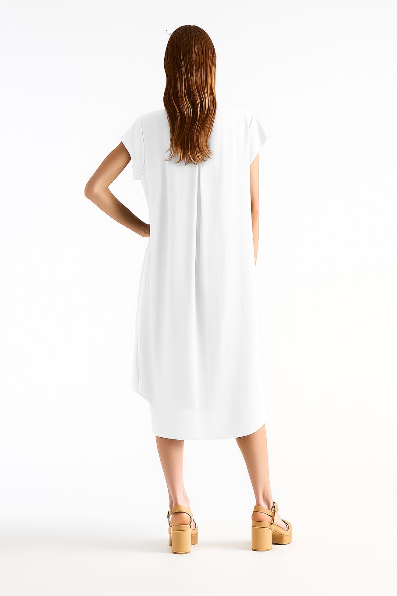 Woman wearing Slide Dress in White by Mela Purdie F67 3269, back view showing the curved hem.