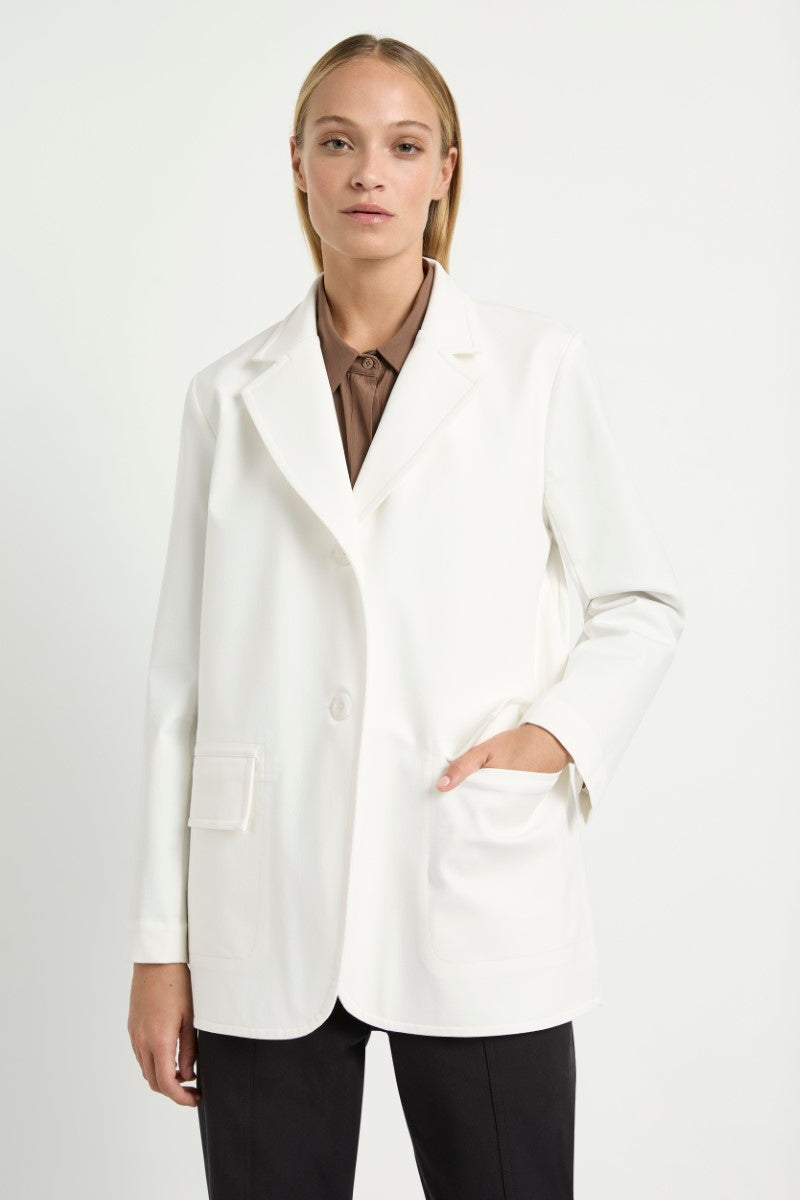 Woman wearing Stretch Blazer in Ivory by Mela Purdie F414 4129, front detail showing the patch pockets.