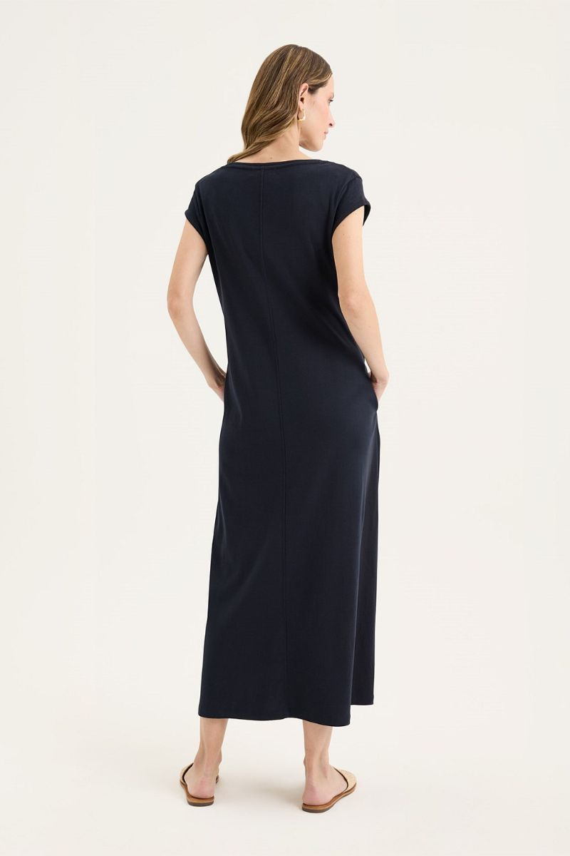 Woman wearing a navy blue dress on a white background