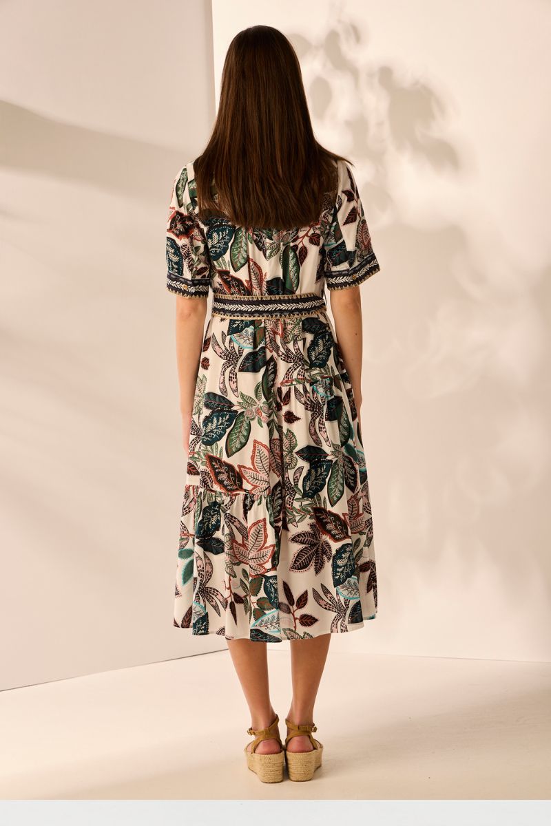Back view of Woman wearing a floral dress against a plain background