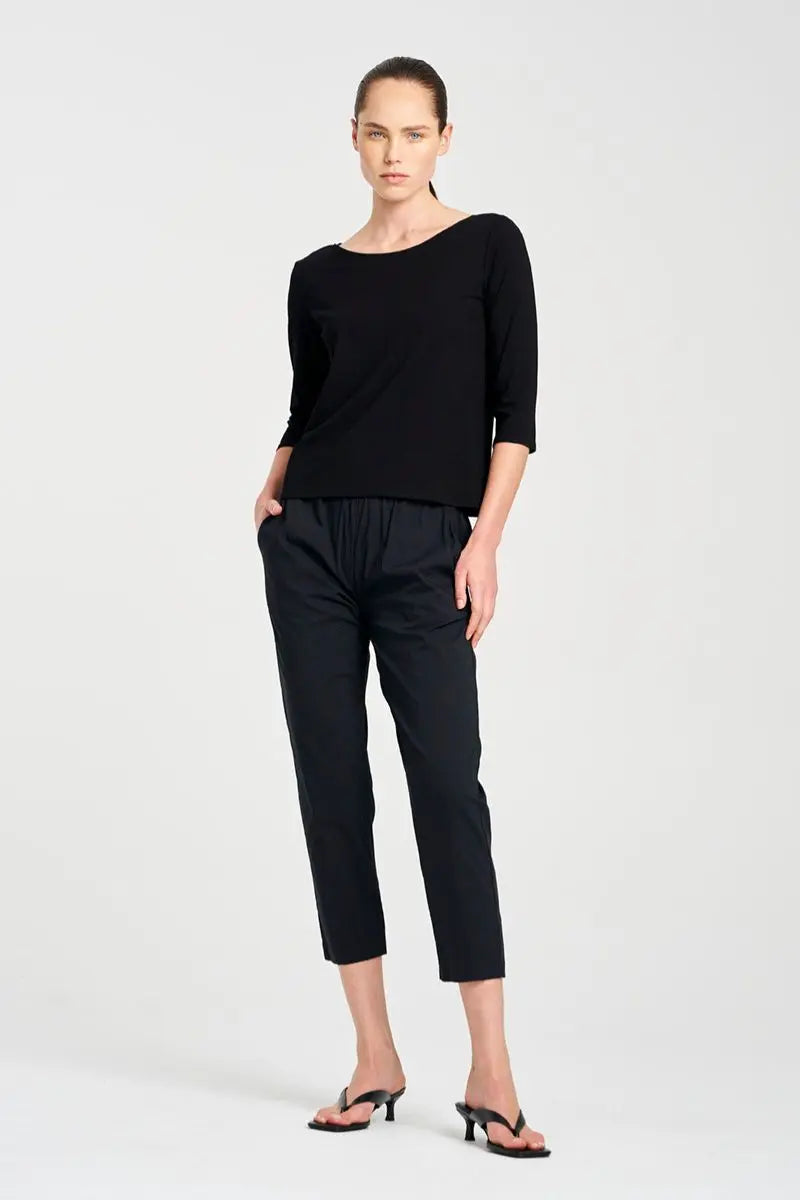 Woman wearing a black outfit on a white background