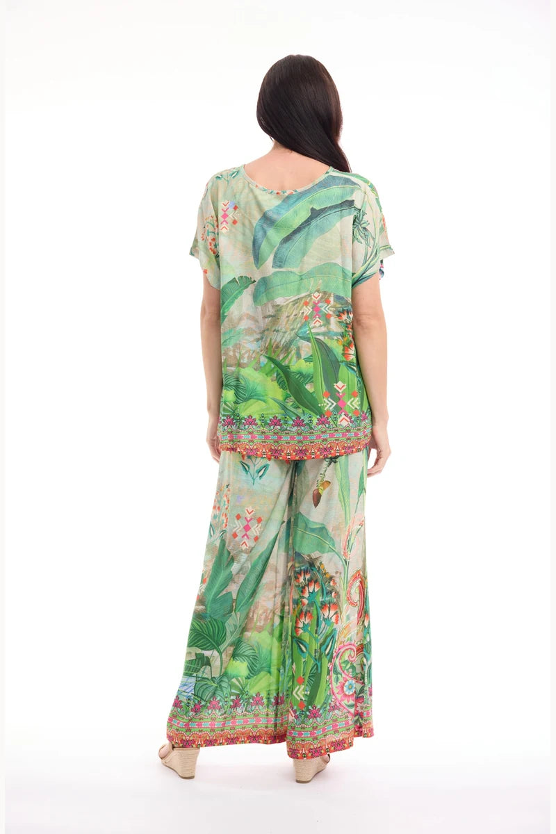 Woman wearing Orientique Digital Pant Flamengo 76074F back view styled with coordinating pleated top