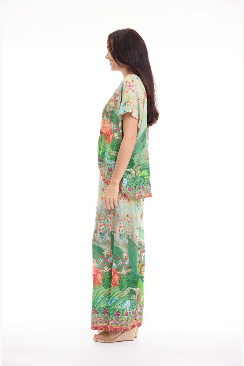 Woman wearing Orientique Digital Pant Flamengo 76074F side view styled with coordinating pleated top