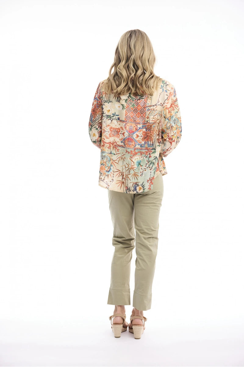 Woman wearing Orientique Gordes Round Neck Button-Through Top Print 23173 back view showing patterned fabric and dipped hem