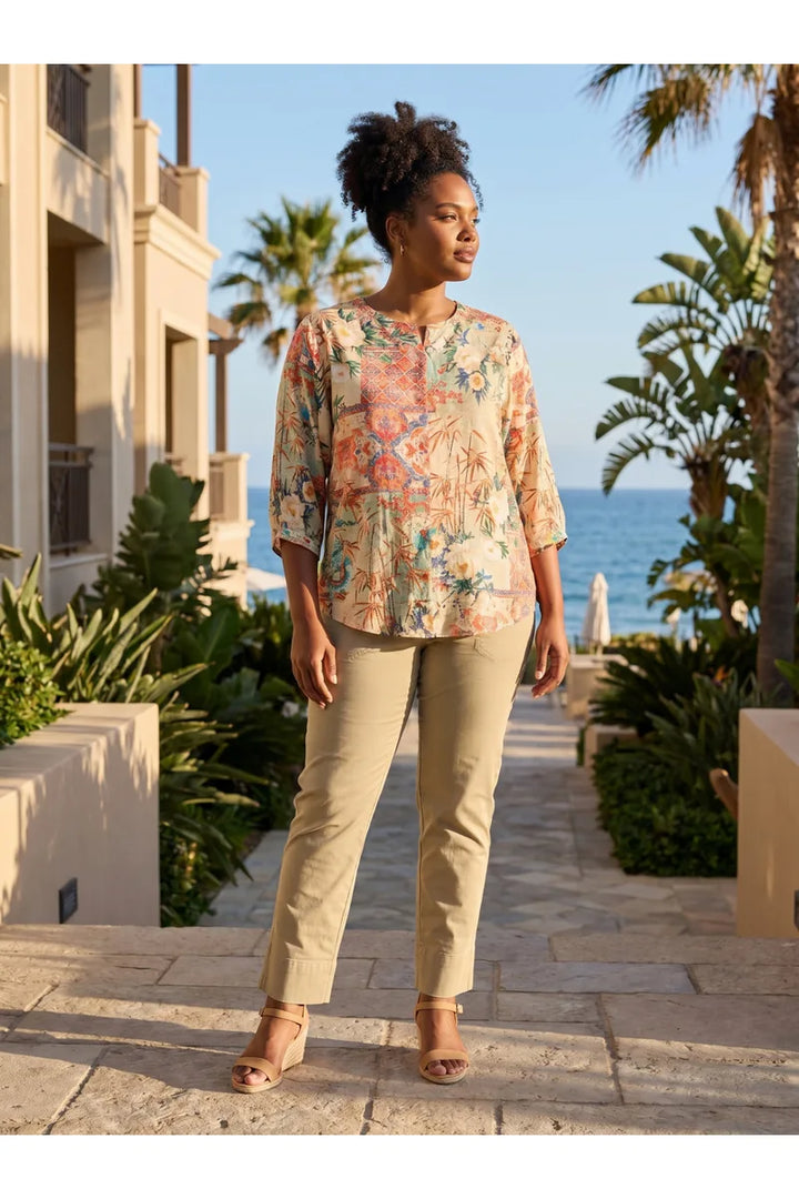 Woman wearing Orientique Gordes Round Neck Button-Through Top Print 23173 outdoor front view styled with beige trousers
