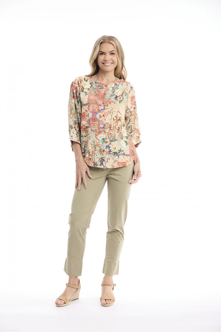 Woman wearing Orientique Gordes Round Neck Button-Through Top Print 23173 studio front view showing three-quarter sleeves and patterned fabric