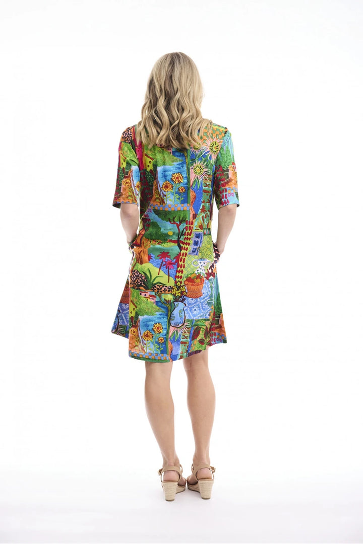 Woman wearing Orientique Le Moulin Contemporary Dress Second 40278 back view showing colourful print and short sleeves