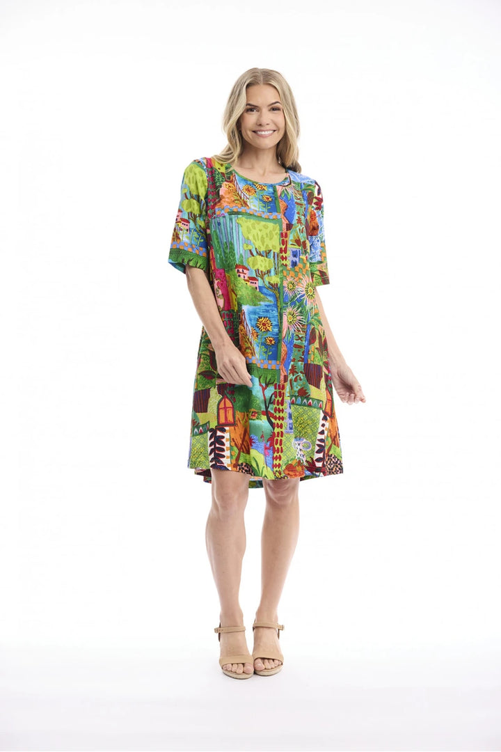 Woman wearing Orientique Le Moulin Contemporary Dress Second 40278 studio front view with colourful landscape print and short sleeves