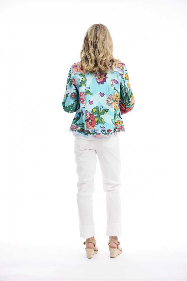 Woman wearing Orientique Provence Fringe Jacket Print 62823 back view showing pastel multicolour pattern and fringe hem