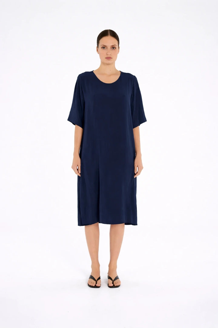 Woman wearing Plaza Dress in Navy by Mela Purdie F67 3004, front view.