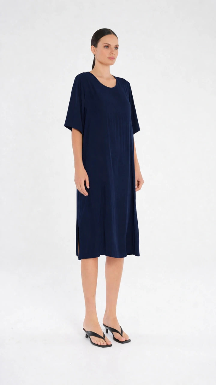 Woman wearing Plaza Dress in Navy by Mela Purdie F67 3004, side view.