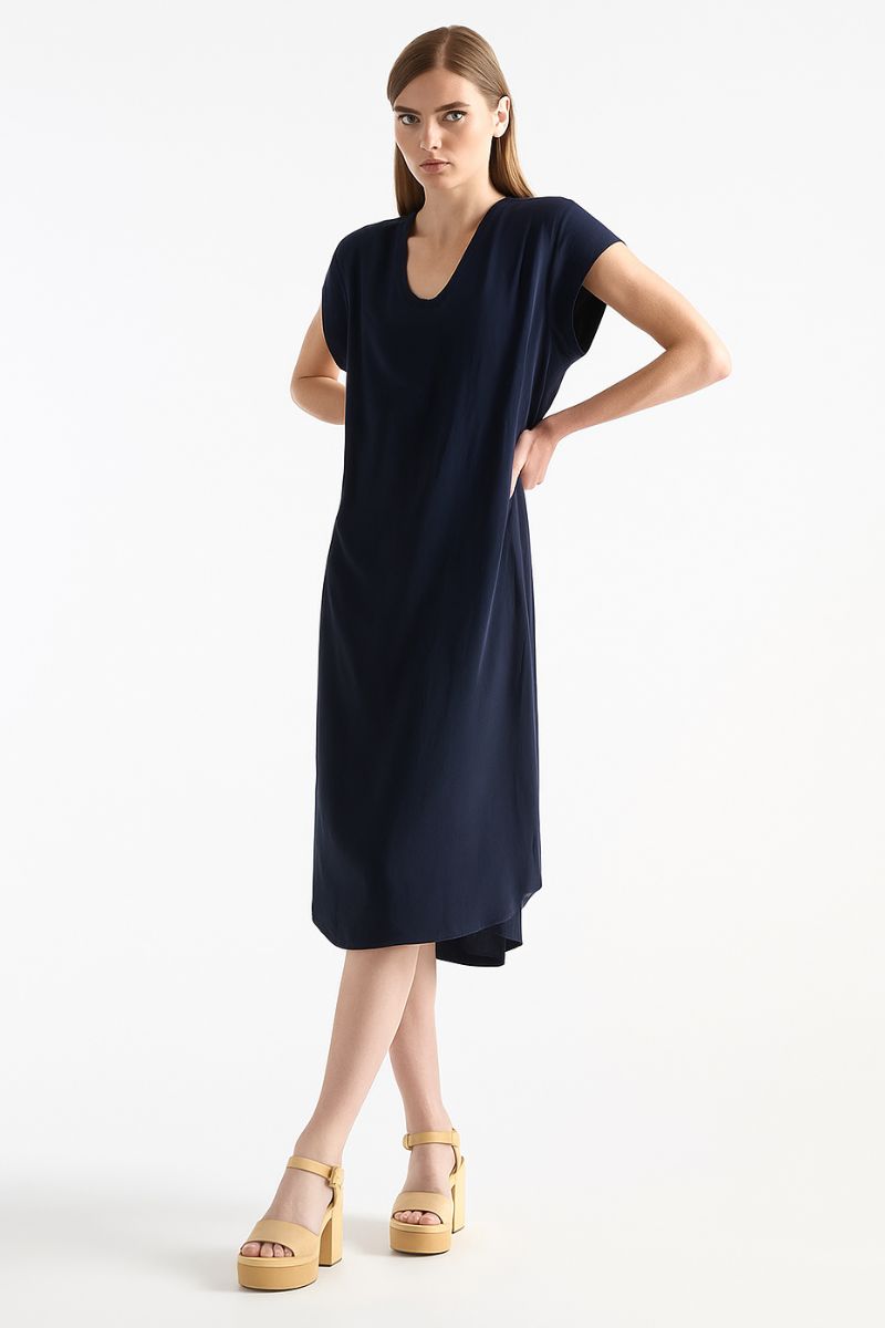 Woman wearing a navy blue dress on a white background