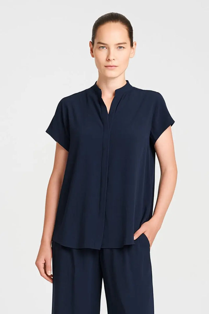 Woman wearing Mela Purdie F67 8629 Soft Stand Shirt in Navy stand collar detail
