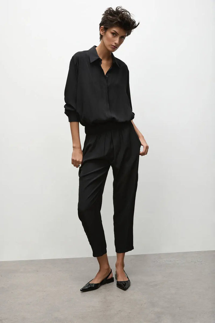 Woman wearing Soft Capri in Black by Mela Purdie F67 1615, full length three quarter view.