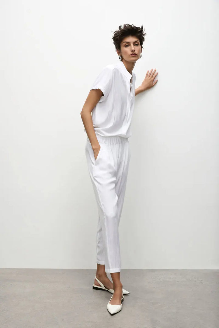 Woman wearing Soft Capri in White by Mela Purdie F67 1615, full length side view.