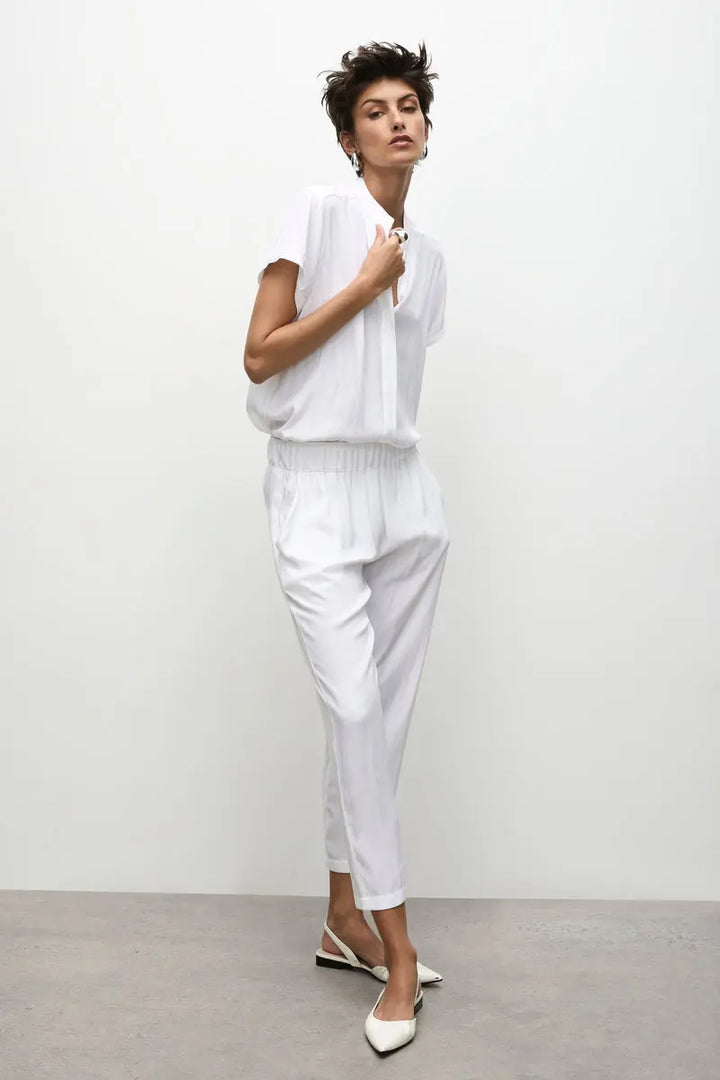 Woman wearing Soft Capri in White by Mela Purdie F67 1615, full length three quarter view.
