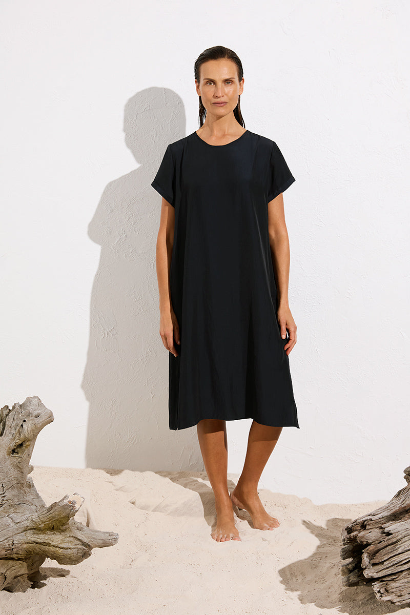 Woman wearing Travel T Dress in Maché F67 3203 by Mela Purdie in Black, front outdoor view.