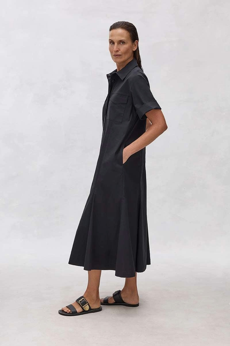 Woman wearing a Mela Purdie Trunk Dress F65 3312 in French Navy standing against a white background