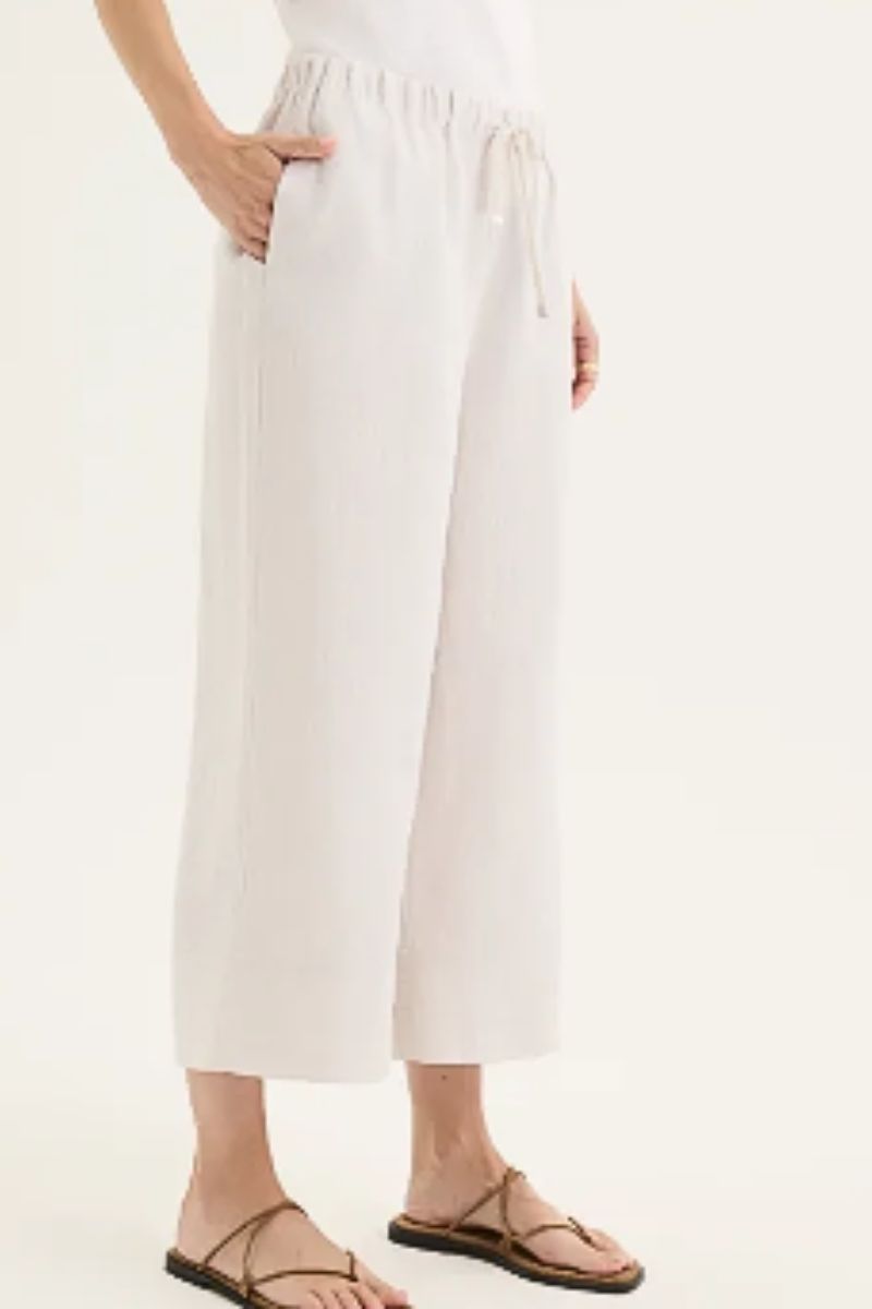 Person wearing twine colour pants on a plain background