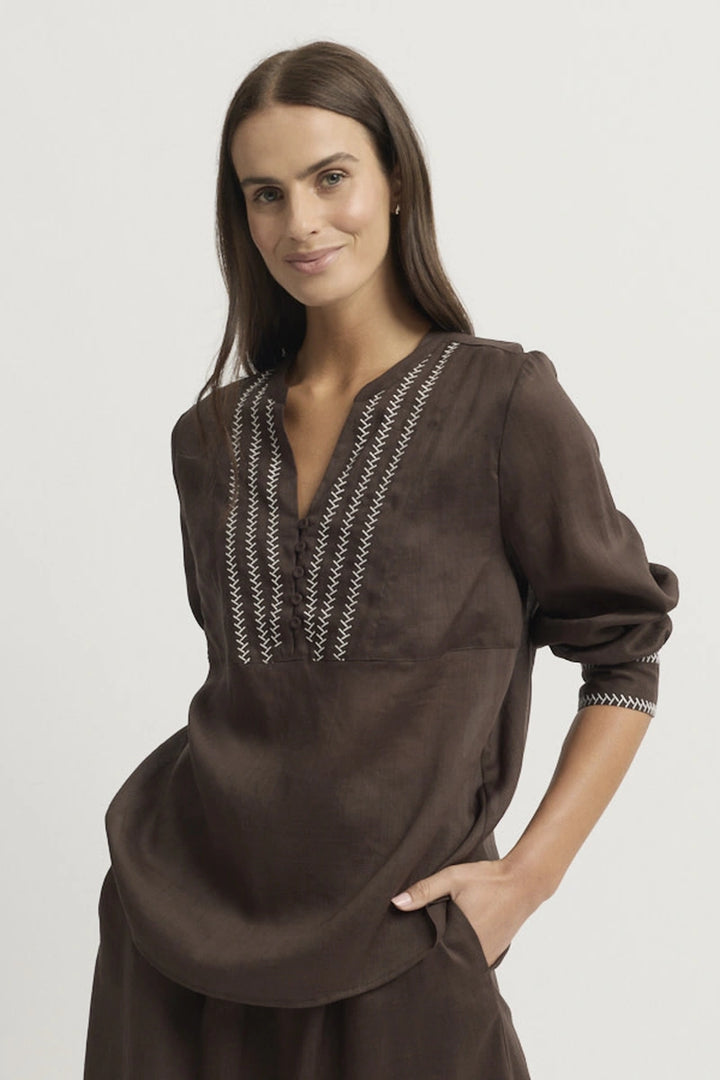 Front model view of the Yarra Trail Grace Blouse in Coco showing the V neckline, contrast embroidered front panel, three-quarter sleeves and curved hem.