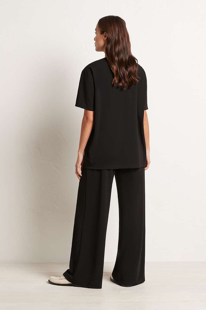 Woman wearing Mela Purdie F007 1777 Palazzo Pant in Black back view